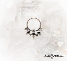 Adorn yourself with Vesta body jewelry. Hand-crafted 9.25 sterling silver with colored crystal inlay, wear it in your septum, side nostril, or wear it as an earring. Please note all nose jewelry is non-refundable. ▪ 𝐃𝐈𝐌𝐄𝐍𝐒𝐈𝐎𝐍𝐒 ▪ * 12 mm x 15 mm * 18 Gauge * 8 mm Inner Diameter ▪ 𝐏𝐀𝐂𝐊𝐀𝐆𝐄 𝐈𝐍𝐂𝐋𝐔𝐃𝐄𝐒 ▪ * One nose jewelry, as pictured. ▪ 𝐉𝐄𝐖𝐄𝐋𝐑𝐘 ▪ * https://www.etsy.com/shop/vedora ▪ 𝐃𝐈𝐒𝐂𝐎𝐔𝐍𝐓 𝐂𝐎𝐃𝐄𝐒 𝐀𝐍𝐃 𝐍𝐄𝐖 𝐃𝐄𝐒𝐈𝐆𝐍 𝐑𝐄𝐋𝐄𝐀𝐒𝐄𝐒 ▪ * https://www Sterling Silver Body Jewelry As Gift, Unique Sterling Silver Body Jewelry For Gifts, Unique Sterling Silver Body Jewelry Gift, Nickel-free Metal Body Jewelry, Pierced Sterling Silver Body Jewelry As Gift, Internally Threaded White Gold Septum Ring In Sterling Silver, Sterling Silver Pierced Body Jewelry As Gift, Sterling Silver Body Jewelry, Sterling Silver Birthstone Piercings