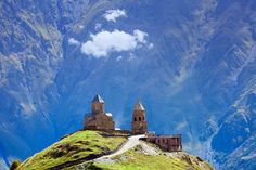 an old castle sitting on top of a mountain