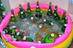 an inflatable tub filled with lots of beer bottles