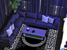 a living room filled with blue couches and pillows on top of a black rug