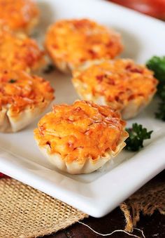 small appetizers on a white plate with parsley