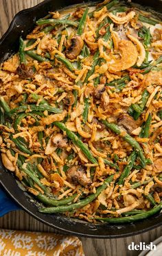 green bean casserole with mushrooms and onions in a cast iron skillet