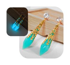 Show off your love of Final Fantasy XIV in a subtle way with these FFXIV Glow in the Dark Aetheryte Earrings! Whether you're at a formal event or a casual outing, these illuminating earrings make a striking statement that is sure to turn heads. Day or night! 𝑬𝒍𝒆𝒈𝒂𝒏𝒕 𝑫𝒆𝒔𝒊𝒈𝒏: These stud style earrings flaunt a glow-in-the-dark, multifaceted resin Seafoam Green crystal that is wrapped in a gold-colored filigree, ensuring you shine in any light. The base of the earring features a sparkly, transparent diamond-esque rhinestone. Extra large stud backings make sure these stay firmly on your ear.  𝑳𝒖𝒙𝒖𝒓𝒚 𝑴𝒆𝒆𝒕𝒔 𝑪𝒐𝒎𝒇𝒐𝒓𝒕: Deceptively lightweight, these long dangle earrings are designed for easy wear, so you can flaunt your style all day (or night) long without discomfort Dark Seafoam Green, Crystal Resin, Stud Style, Final Fantasy Xiv, Long Dangle Earrings, Single Earring, Metal Earrings, Seafoam Green, Green Crystals