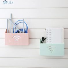 a pink box with wifi connected to it on the wall next to a blue and white phone charger