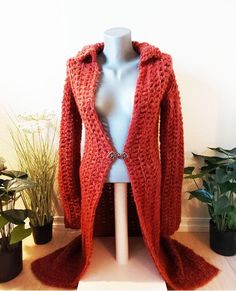 Long, soft, beautiful rust-red crochet coat in medium size with metal hook closure. A shaping, elegant jacket for all body-types. Indulge in the luxurious warmth and style of this exquisite handmade crochet jacket in a rich rust red hue. Crafted with meticulous attention to detail, this long, soft jacket is a true standout piece. The intricate crochet work adds a touch of elegance and charm, making it a versatile addition to your wardrobe. Whether layered over a simple tee or dressed up for a  s Red Crochet Long Sleeve Outerwear, Fitted Knitted Red Outerwear, Hand Knitted Long Outerwear For Fall, Elegant Hand Knitted Fall Outerwear, Red Bohemian Crochet Outerwear, Hand Knitted Fitted Outerwear For Fall, Fall Fitted Hand-knitted Outerwear, Fall Hand-knitted Fitted Outerwear, Elegant Crochet Cardigan For Fall