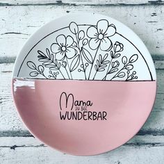 a pink and white plate with the words mama wunderbar written on it in black ink