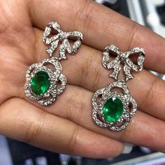 ONE OF A KIND HANDCRAFTED EARRINGS. STUNNING 5.71TCW, Certified ZAMBIAN Emerald earrings. UNIQUE BOW DESIGN! VERY CUTE! ONE OF A KIND! PERFECT DANGLING EARRINGS FOR EVERY OCCASION! Everlastingly precious with genuine, untreated emeralds and natural diamonds, set in handcrafted 18K solid white gold earrings. What you see is what you get! One of a kind earrings! Our jewelry are specially designed, and are delicately handcrafted by local Thai, professional goldsmiths, who have had decades of experi Luxury Pear-shaped Emerald Earrings, Luxury Pear-shaped Chandelier Earrings For Formal Events, Luxury Gia Certified Dangle Diamond Earrings, Luxury Gemstone Chandelier Earrings For Formal Occasions, Luxury White Gold Chandelier Earrings Pear-shaped, Elegant Gia Certified Emerald Earrings, Luxury Oval Bridal Earrings For Formal Occasions, Luxury Oval White Gold Bridal Earrings, Formal Diamond Gemstone Chandelier Earrings