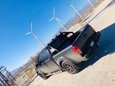 a truck parked in front of wind turbines