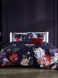 an image of a bedroom setting with flowers on the bedspread and pillow cases