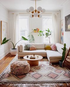 a living room filled with furniture and plants