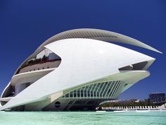 the building is designed to look like it has an unusual roof that extends into the water