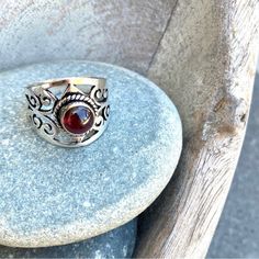 Sundance Garnet Ring. Deep Red Center Gemstone, Raised Dome Shaped. Has Translucent Glow In The Light. Beautiful Carved Sterling Silver Wide Band With Negative Space Floral Motifs. Lovely Jewelry Piece For The Esteemed Jewelry Collector. Elegant Bohemian Piece. Great Gift Ring Size 8 Sundance Sterling Silver Gemstone Ring Red Garnet Gemstone Catalog Boutique Vintage Band Solitaire Heirloom Jewelry Collection Women's Sundance Jewelry, Elegant Bohemian, Heirloom Jewelry, Sterling Silver Garnet Ring, Heirlooms Jewelry, Garnet Ring, Vintage Band, Gift Ring, Garnet Rings