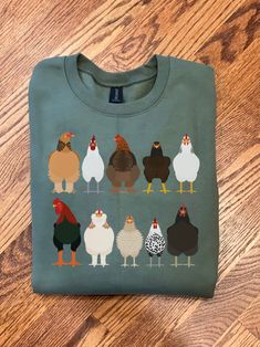 This Chicken Sweatshirt is great for Easter shirts or Women Chicken Shirt! This shirt makes a Funny Easter Shirt or Chicken Mom T-shirt! Our Farm Animal Tee Shirts are great for the Chicken lover or Chicken owner! Use as a Easter Tee or Chicken Tee for the Chicken mama in your life! { S H I R T / D E T A I L S } T-Shirts are 100% ringspun cotton and are UNISEX fit. Sweatshirts (no hood) & Hoodies (with hoods) are 50/50 cotton/polyester Both styles are soft & comfy. They are UNISEX size, fitting Green Novelty Cotton Top, Green Cotton Novelty Top, Novelty Cotton Crew Neck Top, Green Crew Neck Novelty Top, Chicken Sweatshirt, Farm Chickens, Chicken Mama, Funny Easter Shirt, Chicken Owner