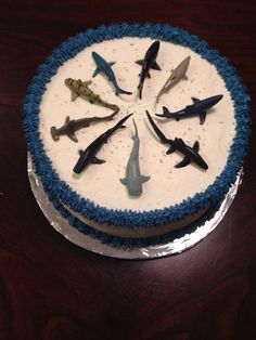 a blue and white cake topped with lots of fake sharks