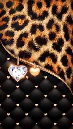 an animal print wallpaper with hearts hanging from it's sides and lights in the middle