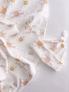 a white and gold baby blanket with the words, be my sunshine printed on it