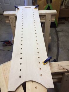 a piece of wood with holes in it being worked on by a hand planer