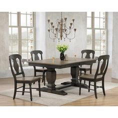 a dining room table with chairs and a chandelier