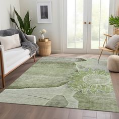 a living room with white furniture and green rug