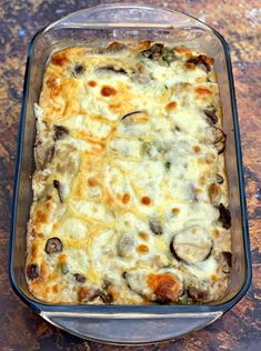 a casserole dish with mushrooms and cheese in a glass baking dish on a table