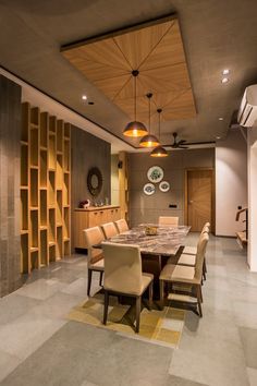 a large dining room table and chairs with wooden shelves