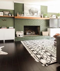 a living room filled with furniture and a fire place under a painting on the wall