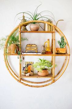 a bamboo shelf with plants and other things on it