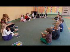 a group of children sitting on the floor in front of each other with their hands together