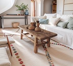 a living room filled with lots of furniture and decor on top of a wooden table