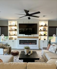 a living room filled with furniture and a flat screen tv mounted on the wall above a fireplace