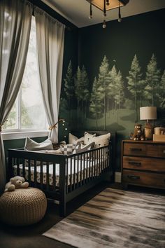 a baby's crib in front of a window with trees painted on the wall