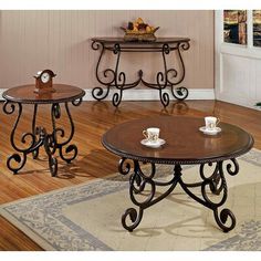 three tables sitting on top of a hard wood floor next to a wall mounted clock