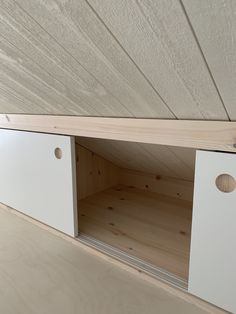 the inside of a wooden cabinet with two doors