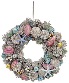 a christmas wreath with shells and starfishs hanging from the front, on a white background