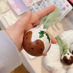 a hand holding an easter egg decorated to look like a reindeer