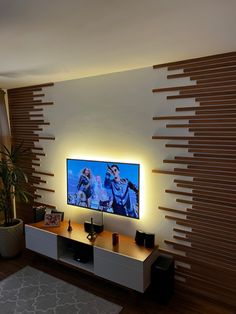 a flat screen tv sitting on top of a wooden entertainment center in a living room