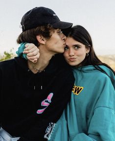 a young man and woman kissing each other