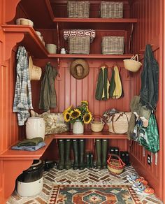 a mud room with sunflowers and boots on the shelf next to an entryway