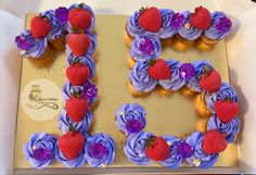 the letter e is made out of cupcakes and decorated with strawberries on top