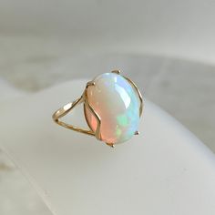 This stunning ring is set in 14k Solid Yellow Gold with Natural Ethiopion Opal with utmost precision. It is an unique statement gemstone ring for nearly every occasion and is completely hassle-free jewelry. ITEM DETAILS * GEM: Opal * GEM SIZE: 12X16mm * GEM SHAPE: Oval * GEM WEIGHT: 5.80 carats * Gold Purity: 14KT * Gold Weight: 1.64 gram * Total Weight of the Ring: 2.80 gram The Gold purity is guaranteed and it comes with authentic 14KT gold hallmark. Since my items are handmade, they are absol