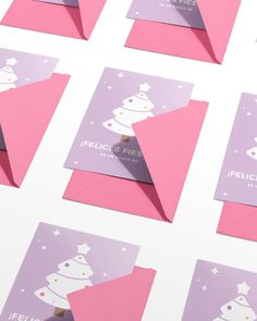 pink and purple envelopes with white stars on them are arranged in the shape of an origami christmas tree