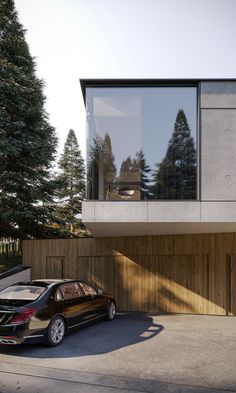 a car parked in front of a house with large windows on the side of it