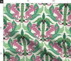 a green, pink and white fabric with leaves on the back ground in front of a ruler