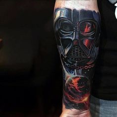 a man's arm with a star wars tattoo on it and a darth vader helmet