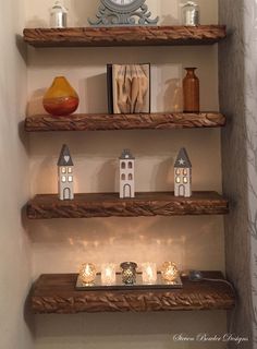 some shelves with candles and pictures on them