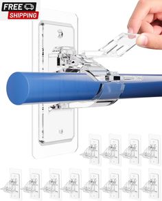 a blue pen is being held up to the side of a white wall with several clips attached