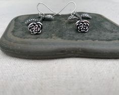 "These are simple stunning and unique! Single stem long rose earrings are exquisitely detailed and have incredible design. They would make the perfect gift for a loved one. A rose that never dies! The earrings measure 1 3/8\" long by 1/2\" wide at the flower part. Over all drop length is 1 1/2\". They hang from simple silver ear wire hooks. Made from allergy free plated silver. I have a matching necklace in my shop if you would like the whole set. Here is a direct link https://etsy.me/31ZuIRh Th Rose Color Flower Drop Earrings, Rose Drop Earrings With Rose Design, Sterling Silver Rose Earrings With Rose Design, Rose Design Sterling Silver Earrings, Boho Hoop Earrings, Silver Chandelier Earrings, Parts Of A Flower, Rose Jewelry, Unique Jewelry Designs