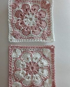 two crocheted squares with pink and white flowers on the top one is square