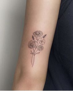 a woman's arm with a flower tattoo on the left side of her arm