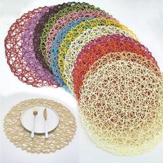 a bunch of different colored doily sitting on top of a white plate next to a clock